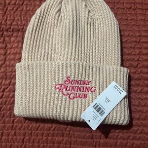 Daily Practice Cream Knit Beanie embroidered with Sunday Running Club.
